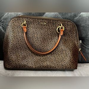 Gently used, large brown purse with gold trim.